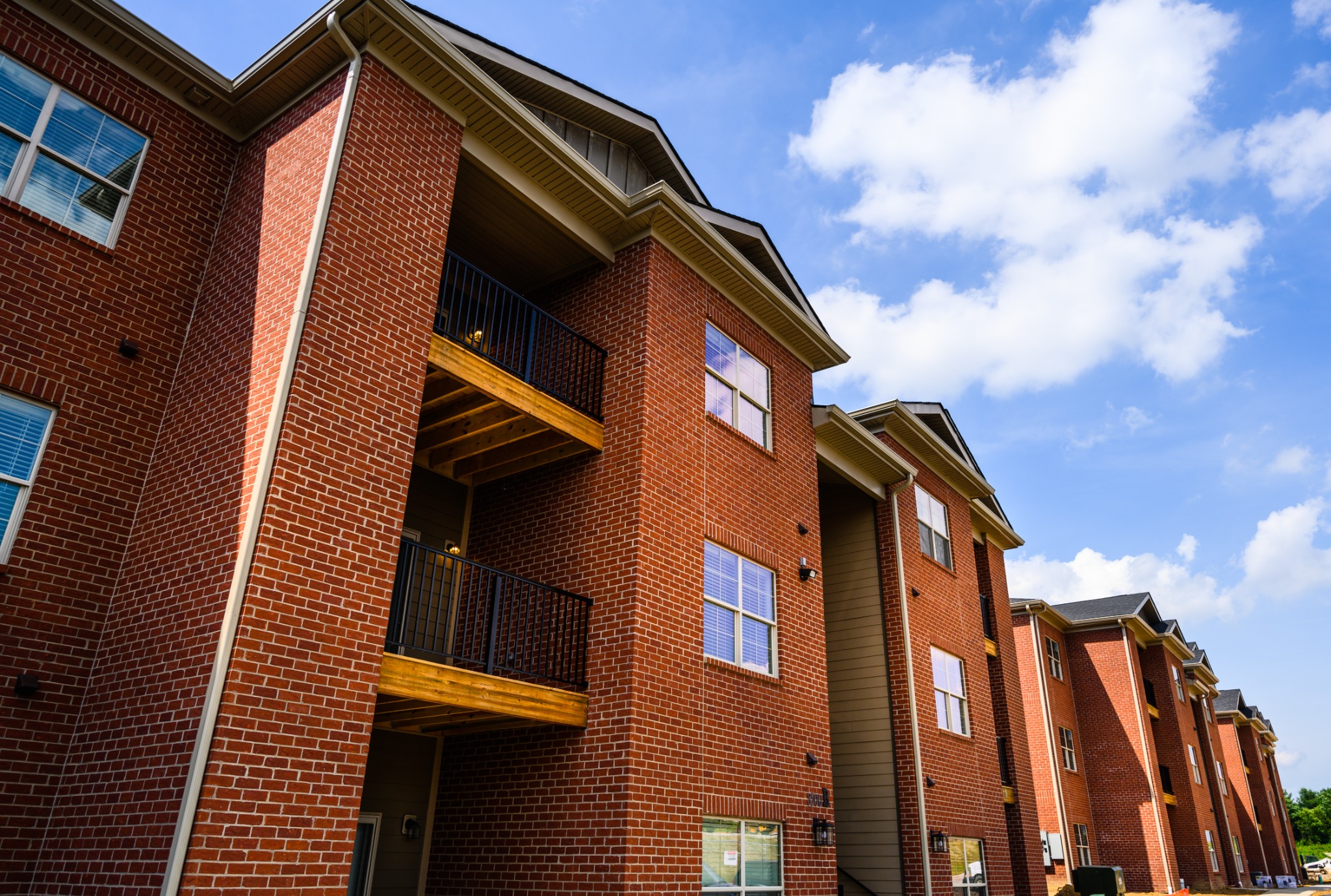 Brick Plum Ridge apartment buildings and private balconies