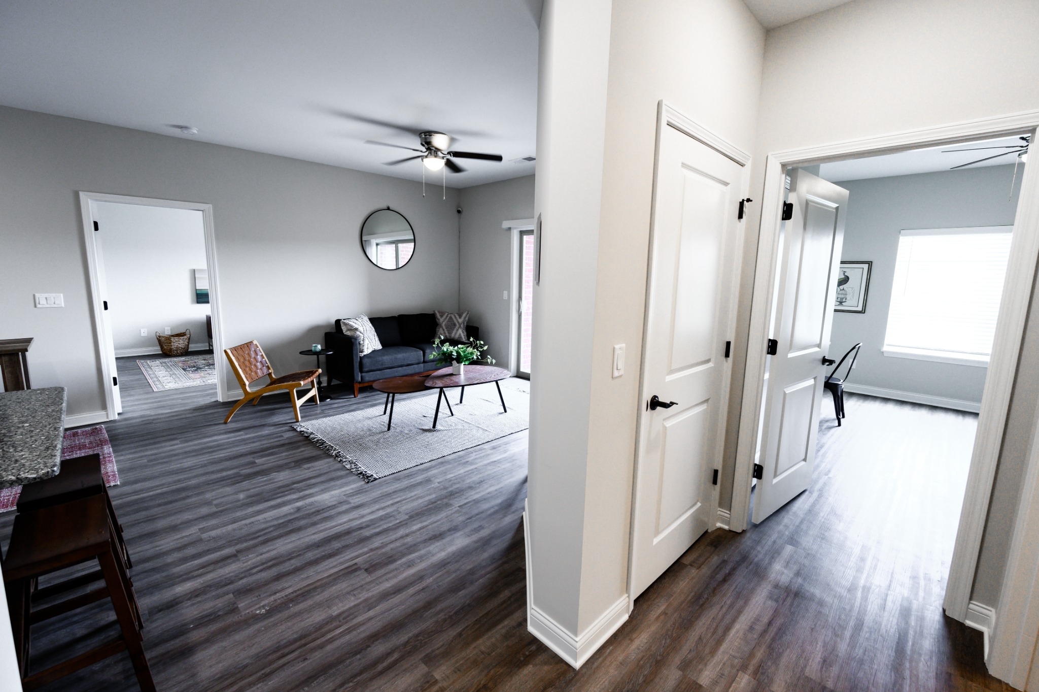 View from hallway into the open living room and bedrooms